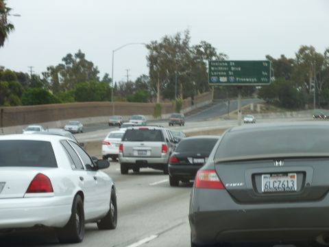 2003 Ford Crown Victoria - Photo of a white Crown Victoria and gray Honda Civic in freeway traffic, not a technical document.
