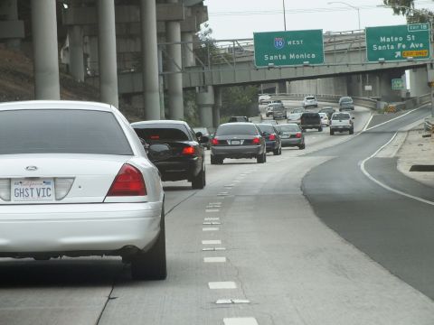 2003 Ford Crown Victoria - Photo of a white Crown Victoria on a freeway beneath a 10 West Santa Monica sign, not a technical document.