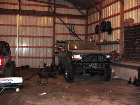 1992 Ford Bronco - Modified 1992 Ford Bronco with a custom front bumper in a workshop setting.