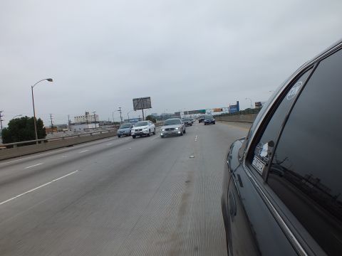 2003 Ford Crown Victoria - Photograph of a multilane freeway with light traffic taken from inside a dark sedan.