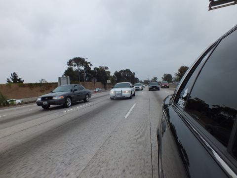 2003 Ford Crown Victoria - Photograph of freeway traffic including a distant truck, taken from inside a dark sedan.
