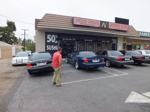 2003 Ford Crown Victoria - Photo of Ford Crown Victoria sedans parked in front of a sushi restaurant strip mall at a car meet.