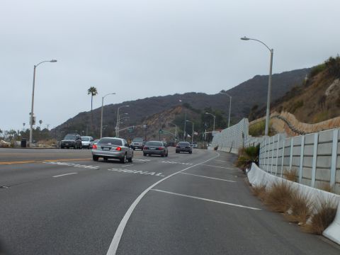 2003 Ford Crown Victoria - Photo of traffic on a coastal highway approaching a signal, not a technical document.