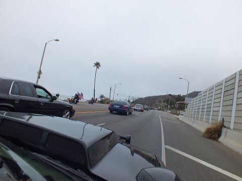 2003 Ford Crown Victoria - Photo of a vehicle convoy on a coastal highway, not a technical document.