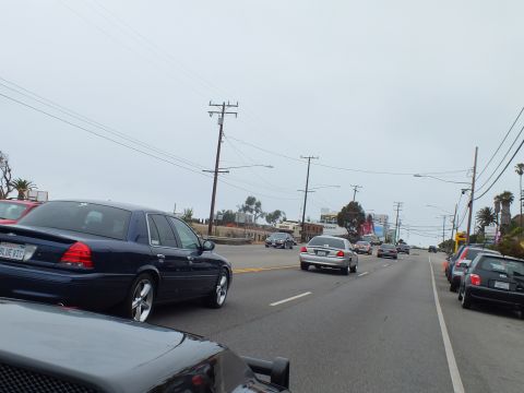 2003 Ford Crown Victoria - Photo of cars on a coastal highway, not a technical document.