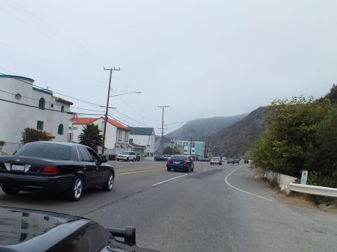2003 Ford Crown Victoria - Photo of a car on a coastal road, not a technical document.