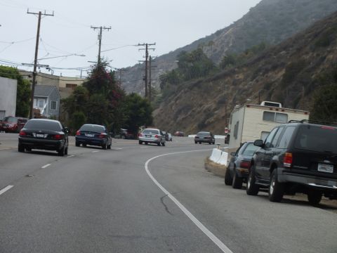 2003 Ford Crown Victoria - Photo of traffic on a coastal road, not a technical document.