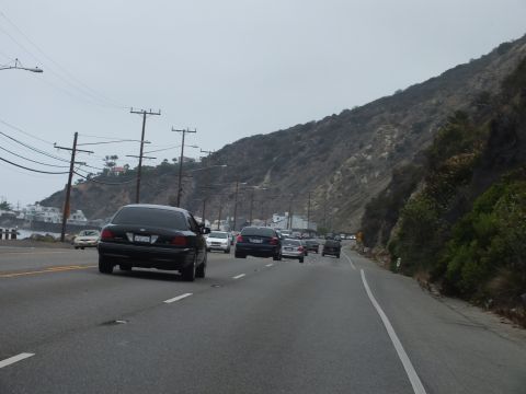 2003 Ford Crown Victoria - Photo of cars on a coastal highway, not a technical document.