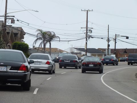 2003 Ford Crown Victoria - Photo of cars at a coastal intersection, not a technical document.