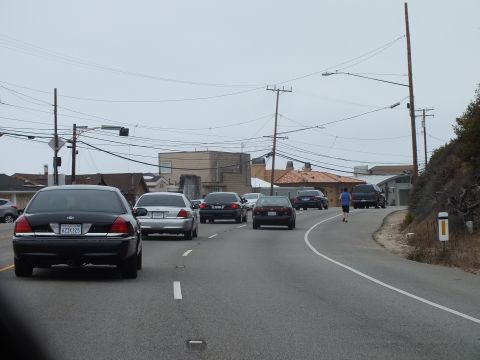 2003 Ford Crown Victoria - Photo of traffic on a coastal highway, not a technical document.