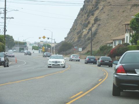 2003 Ford Crown Victoria - Photo of traffic on a coastal highway, not a technical document.