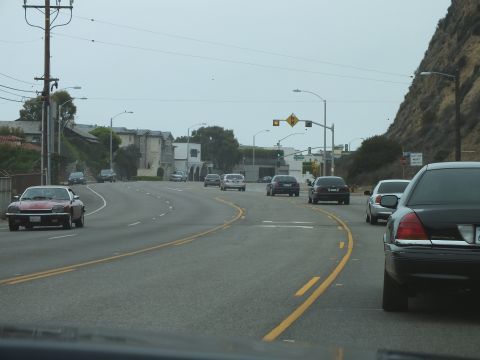 2003 Ford Crown Victoria - Photo of cars on a coastal highway, not a technical document.