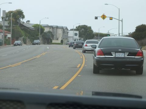 2003 Ford Crown Victoria - Photo of a car on a coastal highway, not a technical document.