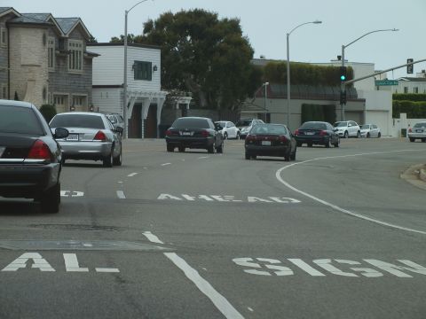 2003 Ford Crown Victoria - Photo of cars at a coastal intersection, not a technical document.