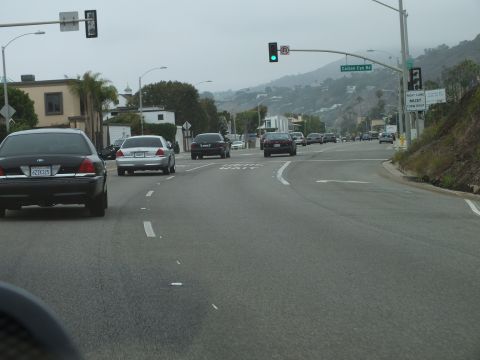 2003 Ford Crown Victoria - Road photo of vehicles on a divided highway with overhead signals and street signs, not a technical document.