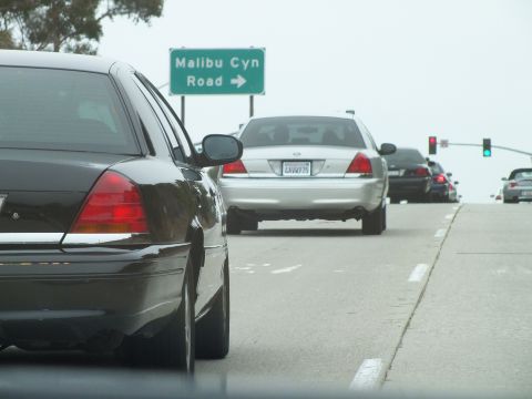 2003 Ford Crown Victoria - Driving photo of vehicles at a traffic light below a Malibu Canyon Road sign, not a technical document.