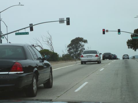 2003 Ford Crown Victoria - Driving photo of vehicles on a multi-lane highway near a Malibu Canyon Road sign, not a technical document.