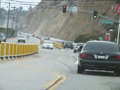 2003 Ford Crown Victoria - Photograph of a Crown Victoria stopped at a highway intersection by a guardrail, not a technical document.
