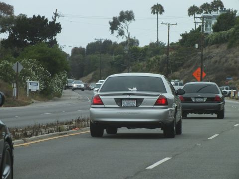 2003 Ford Crown Victoria - Photograph of a silver Mercury and black Crown Victoria in highway traffic, not a technical document.