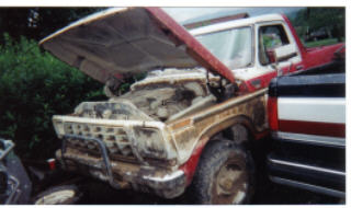 1978 Ford Bronco - 1978 Ford F-150 pickup truck with its hood open, revealing the engine bay.