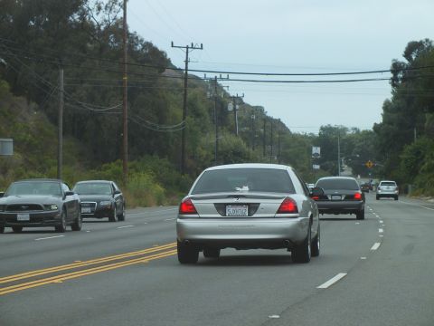 2003 Ford Crown Victoria - Photograph of a Marauder among sedans on a divided road, not a technical document.