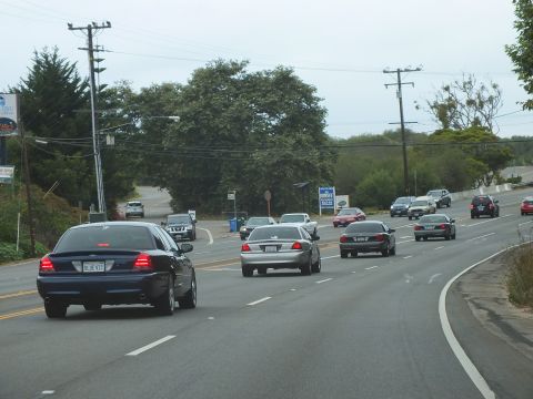 2003 Ford Crown Victoria - Photograph of sedans driving on a multi-lane road, not a technical document.