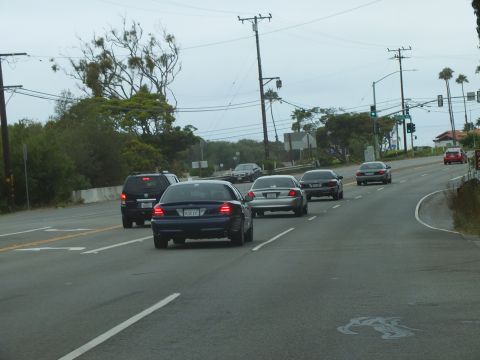 2003 Ford Crown Victoria - Photograph of vehicles on a road approaching a green light, not a technical document.