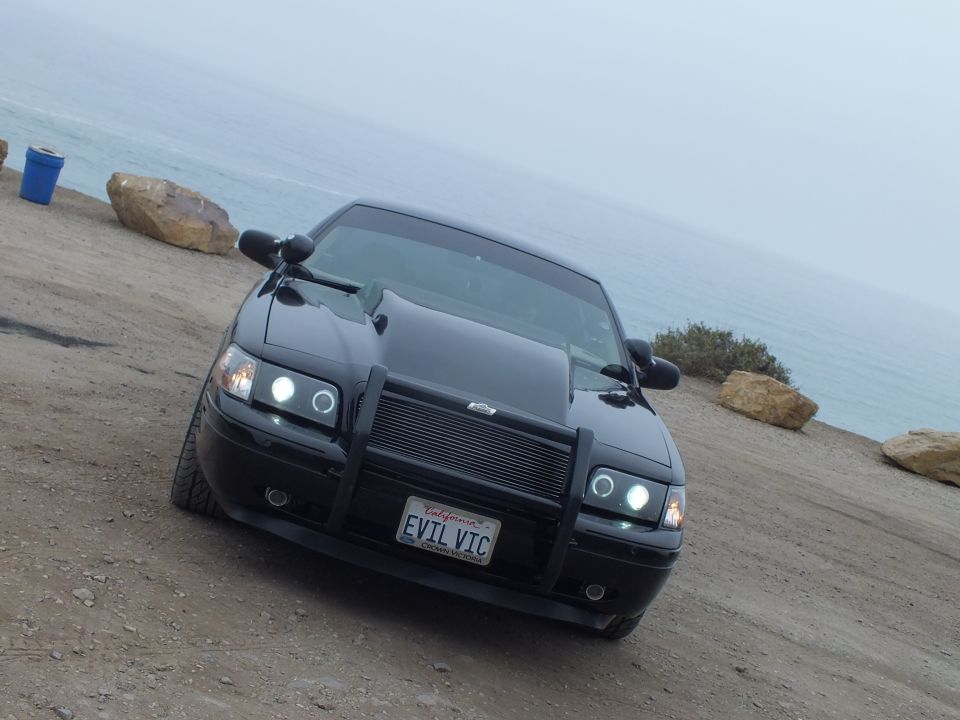 Black customized Crown Victoria 'EVIL VIC' front view with push bar at coast