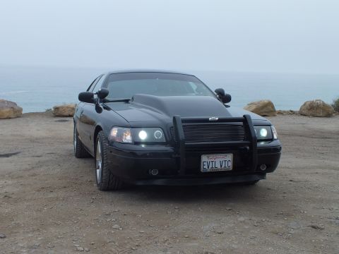 2003 Ford Crown Victoria - Photo of a black customized Crown Victoria at a foggy coastal overlook, not a technical document.