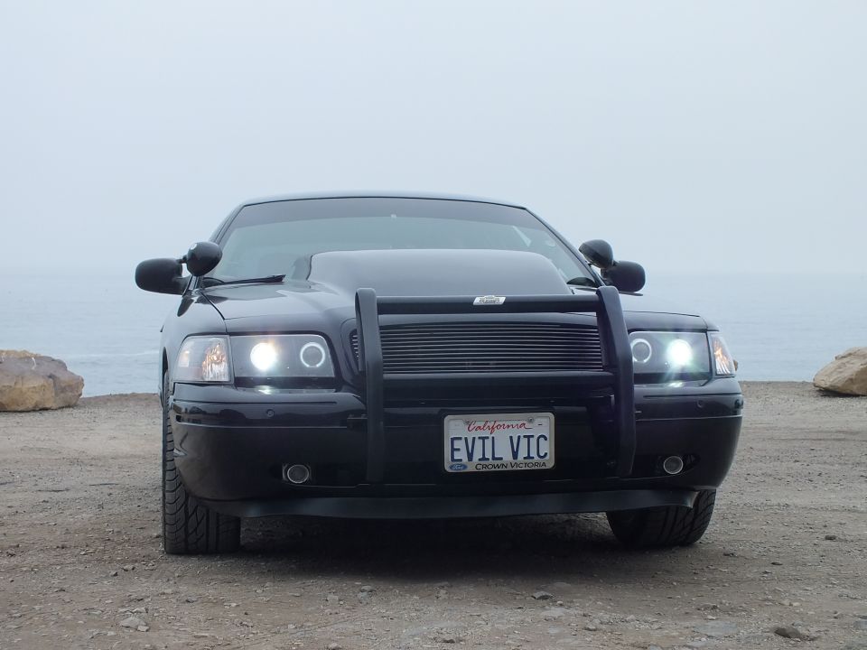 Black 'EVIL VIC' Crown Victoria front view with grille guard at the coast