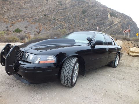 2003 Ford Crown Victoria - Photo of a black customized sedan at a mountain pullout, not a technical document.