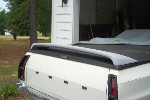 1976 Ford Ranchero - The rear of a white 1976 Ford Ranchero pickup is shown with a spoiler and a tonneau cover.
