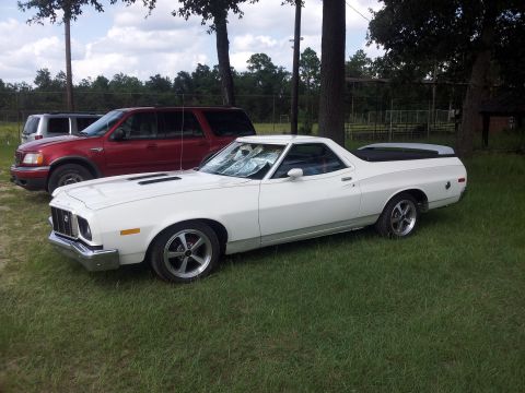 1976 Ford Ranchero - White 1976 Ford Ranchero with aftermarket wheels parked outdoors.