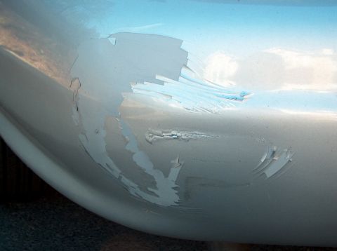 1998 Ford Taurus - The paint is severely chipped and peeling on this vehicle's bumper.