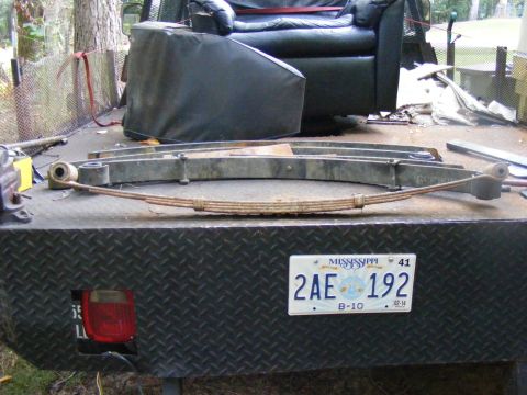 1978 Ford Bronco - Leaf springs and a Mississippi license plate are visible on the back of a truck bed.