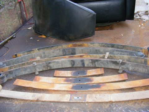 1978 Ford Bronco - Several used leaf springs are laid out, some showing the part number 69E400.