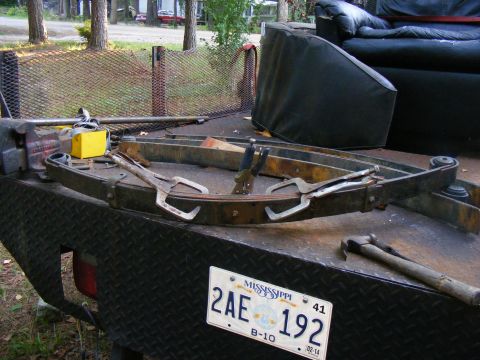1978 Ford Bronco - Leaf springs are secured with clamps on a trailer, ready for work.
