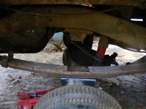 1978 Ford Bronco - A close-up view of the vehicle's undercarriage, focusing on the suspension components like leaf springs and shocks.