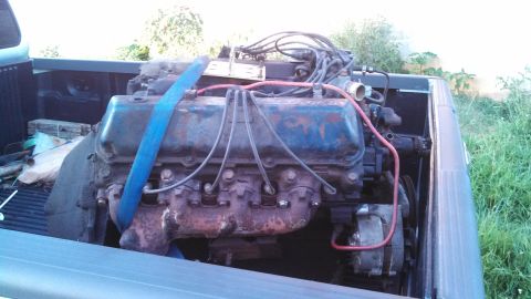 1979 Ford Bronco - Engine removed from a vehicle and loaded into the bed of a pickup truck for transport.