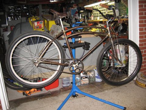 1994 Ford Bronco - Custom cruiser bicycle on a repair stand in a garage setting.
