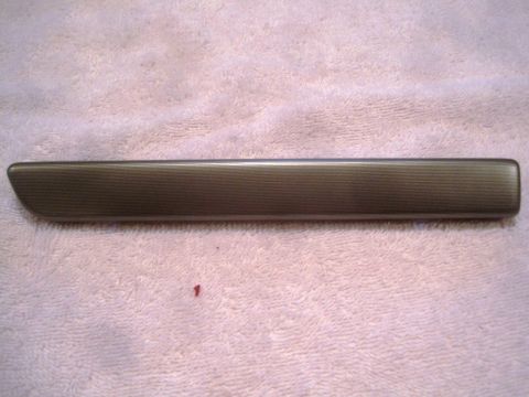1993 Ford Bronco - A single automotive door trim piece is shown against a textured pink background.