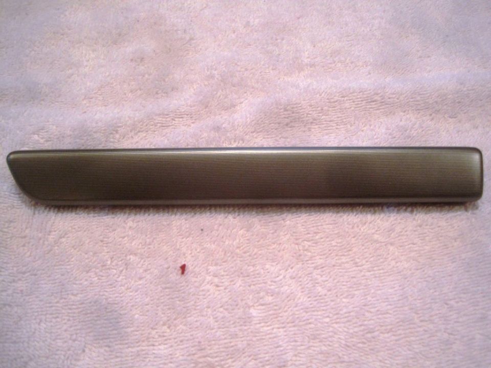 Bronze textured door trim piece on a pink towel