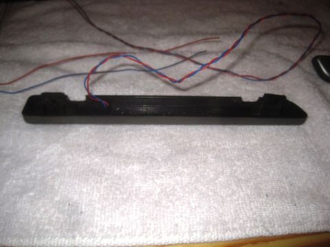 1993 Ford Bronco - This is a black plastic automotive part with wires, possibly from a 1993 Ford Bronco.