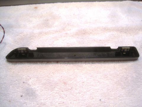 1993 Ford Bronco - This is a black plastic trim piece with metal clips, likely from a vehicle, resting on a towel.