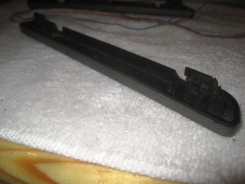 1993 Ford Bronco - This is a black plastic trim piece with wires, likely a car part.