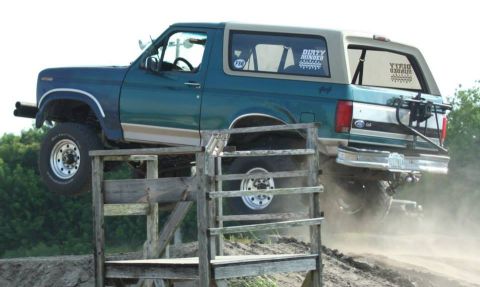 1996 Ford Bronco - This 1996 Ford Bronco navigates an off-road course, kicking up dust as it goes over a wooden ramp.