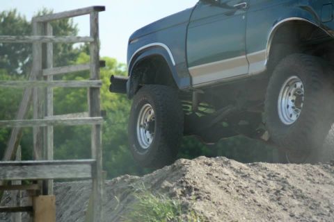 1996 Ford Bronco - This 1996 Ford Bronco is captured mid-air as it navigates an off-road obstacle.
