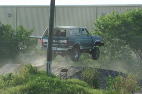 1996 Ford Bronco - This 1996 Ford Bronco takes flight over a dirt track, its off-road capabilities.