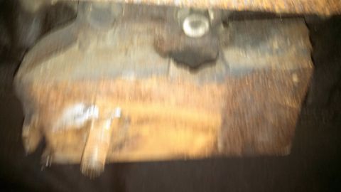 1979 Ford Bronco - This photo shows a rusty, rectangular component from the underside of a vehicle.
