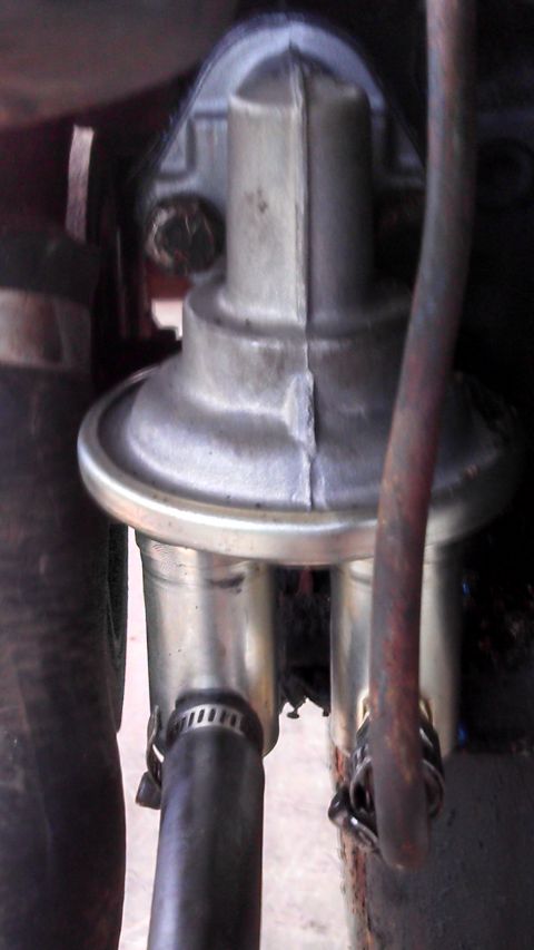 1979 Ford Bronco - Close-up view of a vehicle's fuel pump, showing its connection to fuel lines.